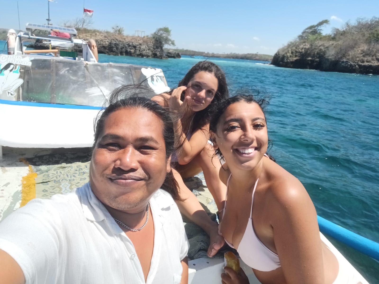 Diko, private driver and tour guide, with guests on a boat trip in Lombok