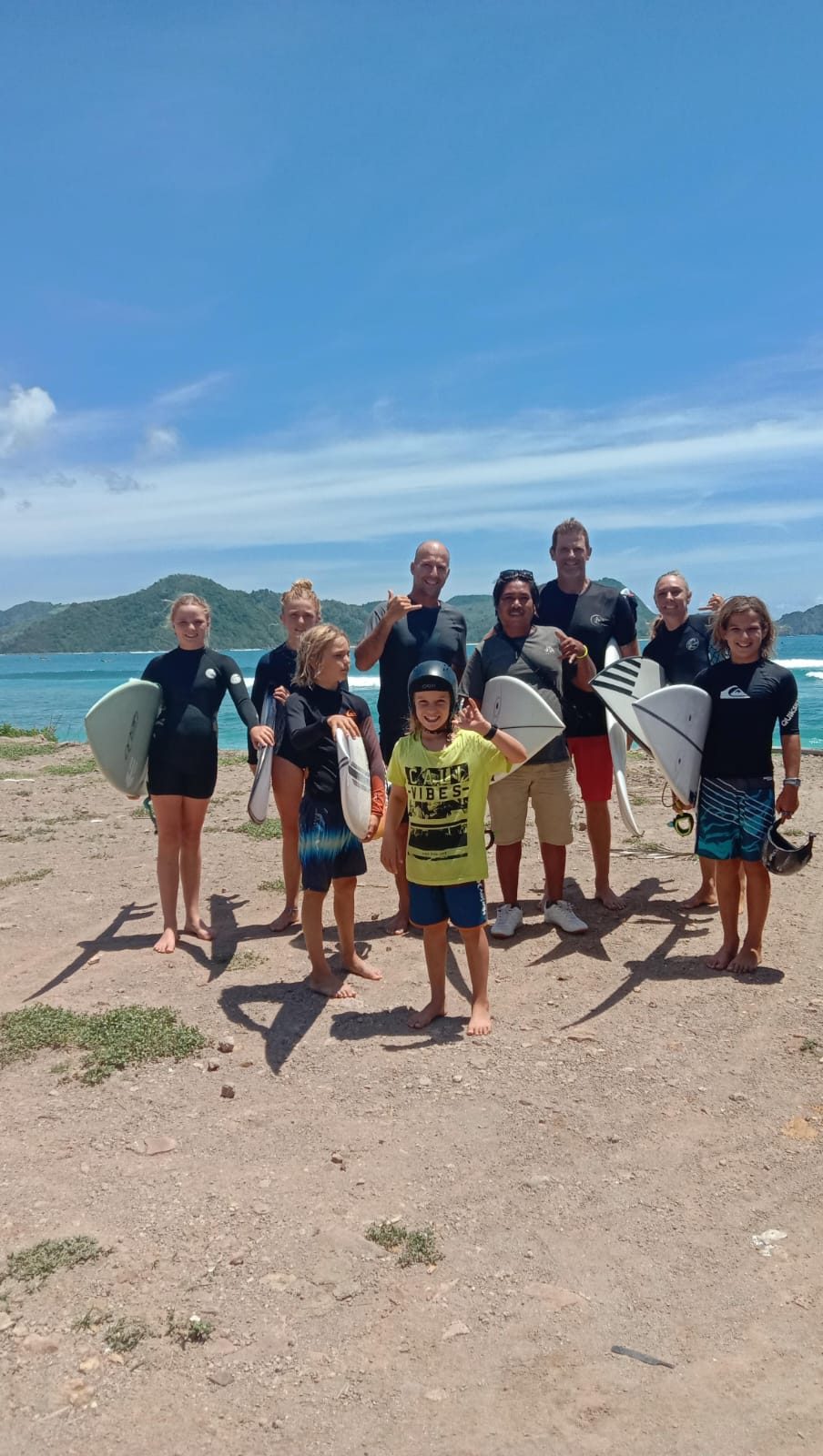 Large tour group with surfboards on a Lombok beach