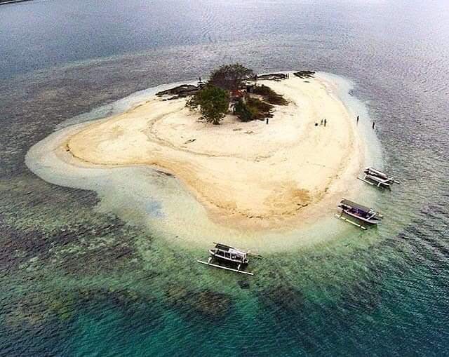 Aerial view of a small island with boats near Lombok