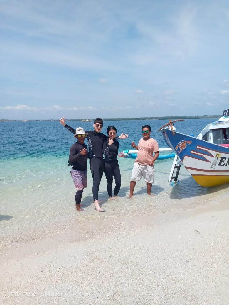 Snorkeling group in wetsuits near Lombok
